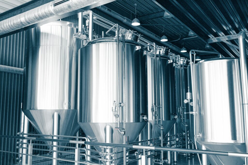 Craft brewery. Large reservoirs, tanks and pipes with manometers in private microbrewery