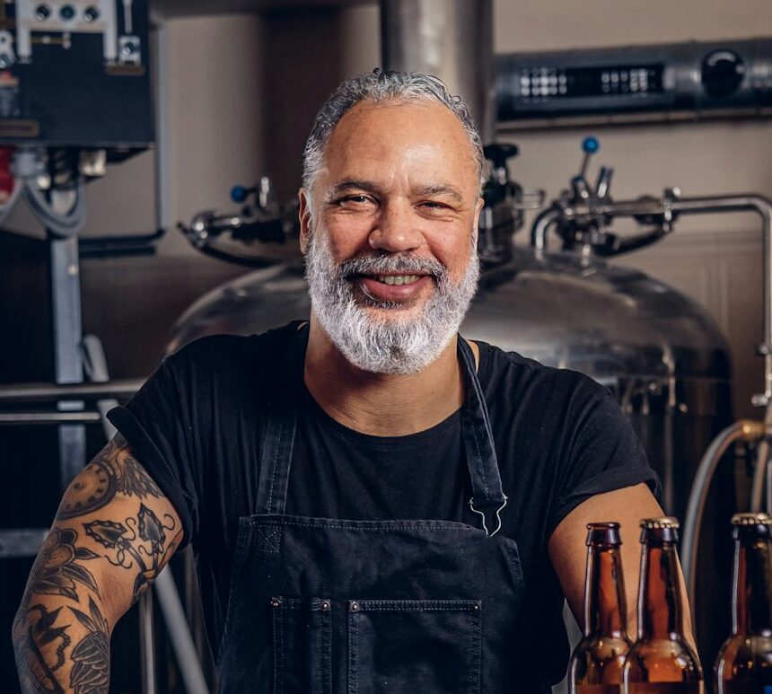 Grandfather brewing business man with tattooed hand in brewery